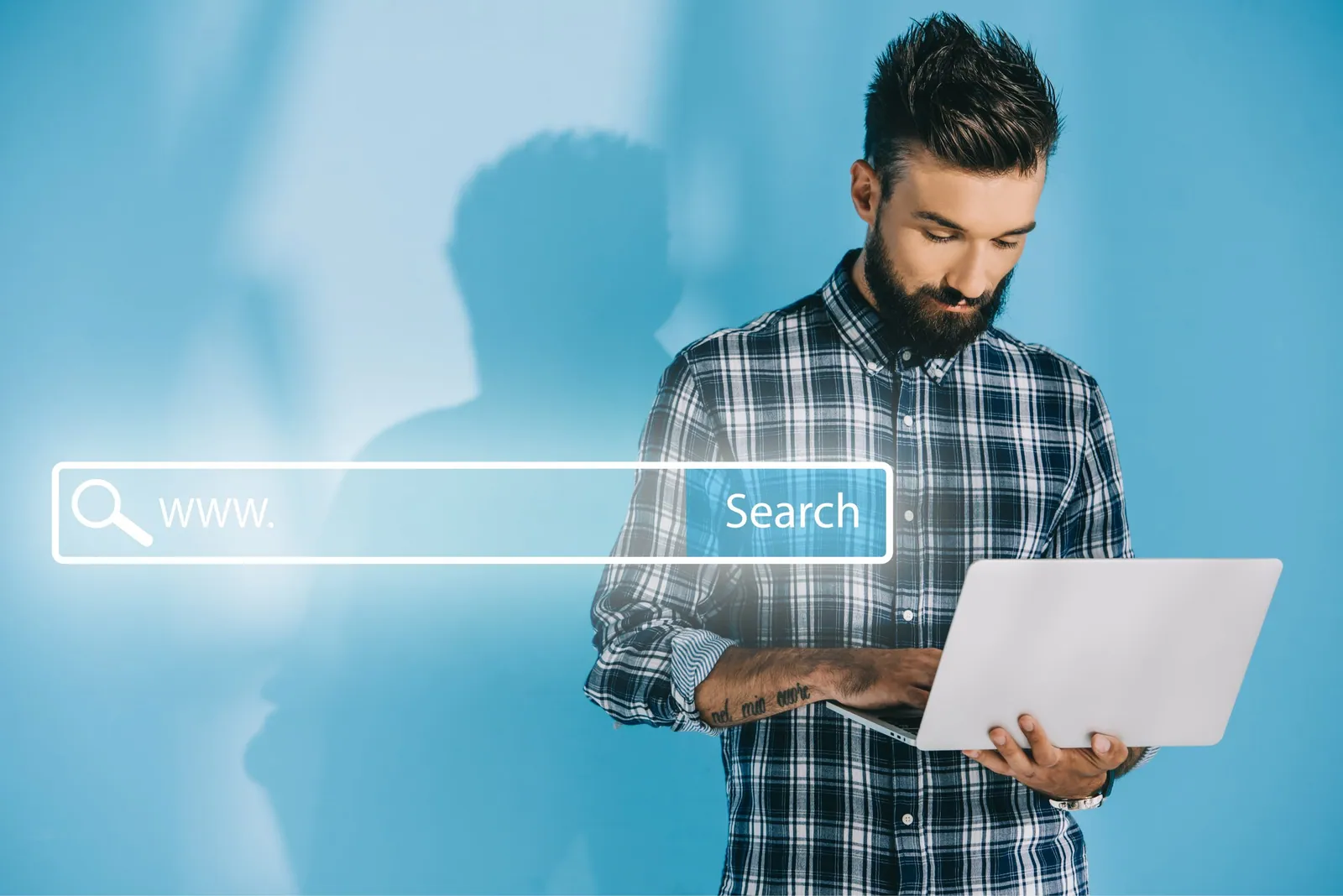 bearded developer using laptop on blue with websi 2022 12 16 18 35 43 utc min